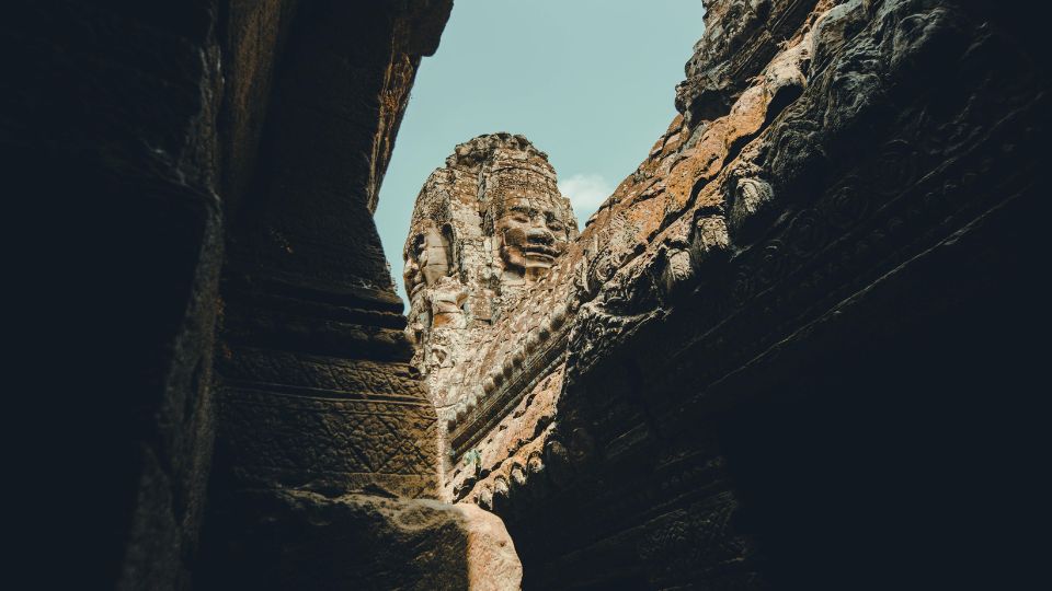 Carved stone face at an Angkor temple, seen from below